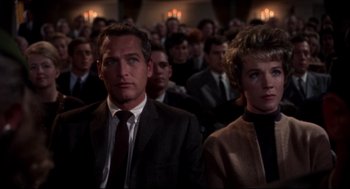 Movie still from “Torn Curtain” (1966), directed by Alfred Hitchcock – A man and a woman are sitting in front of an audience; Close Up shot, Low angle