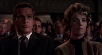 Movie still from “Torn Curtain” (1966), directed by Alfred Hitchcock – A man and a woman are standing in front of a crowd; Close Up shot, Low angle