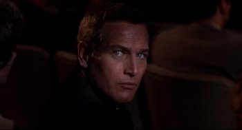 Movie still from “Torn Curtain” (1966), directed by Alfred Hitchcock – A person wearing a suit and tie; Close Up shot, Low angle