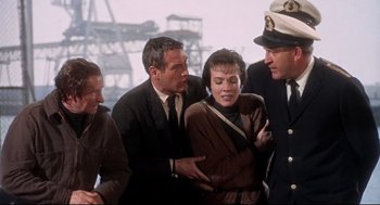 Movie still from “Torn Curtain” (1966), directed by Alfred Hitchcock – A group of people standing next to each other on a dock; Medium shot, High angle