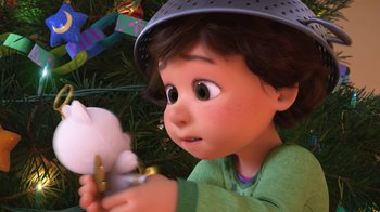 Movie still from “Toy Story That Time Forgot” (2014), directed by Steve Purcell – A child holding a stuffed animal in his hands; Close Up shot, Over the shoulder angle