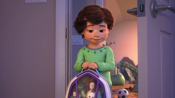 Movie still from “Toy Story That Time Forgot” (2014), directed by Steve Purcell – A little girl is holding a backpack in a room; Medium shot, Over the shoulder angle