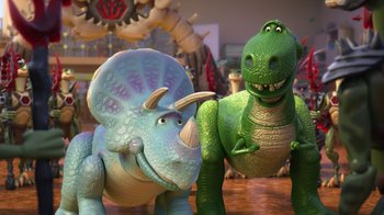Movie still from “Toy Story That Time Forgot” (2014), directed by Steve Purcell – Two toy dinosaurs standing next to each other on the floor; Wide shot, Low angle