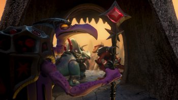 Movie still from “Toy Story That Time Forgot” (2014), directed by Steve Purcell – A purple creature holding a red object; Wide shot, Low angle