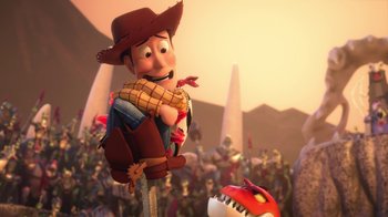 Movie still from “Toy Story That Time Forgot” (2014), directed by Steve Purcell – A toy story character is standing in front of a crowd of people; Wide shot, Over the shoulder angle