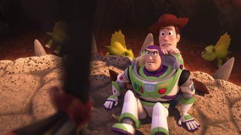 Movie still from “Toy Story That Time Forgot” (2014), directed by Steve Purcell – A couple of people sitting on top of a pile of rocks; Medium shot, Over the shoulder angle