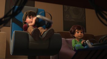 Movie still from “Toy Story That Time Forgot” (2014), directed by Steve Purcell – Two animated characters sitting in a chair with a remote; Medium shot, High angle