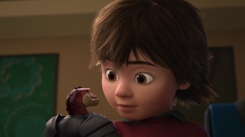 Movie still from “Toy Story That Time Forgot” (2014), directed by Steve Purcell – A young boy is holding something in his mouth; Close Up shot, Over the shoulder angle