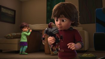 Movie still from “Toy Story That Time Forgot” (2014), directed by Steve Purcell – A young boy holding a stuffed animal while a young girl looks on; Medium shot, Over the shoulder angle