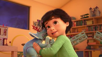 Movie still from “Toy Story That Time Forgot” (2014), directed by Steve Purcell – A young girl holding an elephant in her arms; Medium shot, High angle