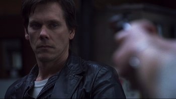 Movie still from “Trapped” (2002), directed by Luis Mandoki – A person wearing a leather jacket; Close Up shot, Over the shoulder angle