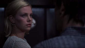 Movie still from “Trapped” (2002), directed by Luis Mandoki – A woman standing next to a man in front of a window; Close Up shot, Over the shoulder angle