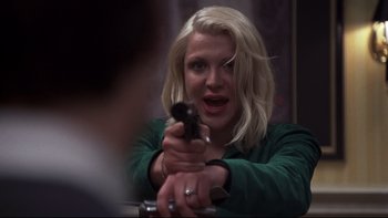 Movie still from “Trapped” (2002), directed by Luis Mandoki – A woman holding a gun pointed at the camera; Close Up shot, Over the shoulder angle