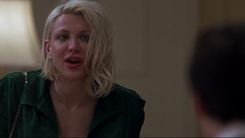 Movie still from “Trapped” (2002), directed by Luis Mandoki – A woman with blonde curly hair is looking at the camera; Close Up shot, Over the shoulder angle
