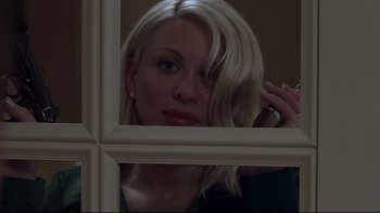 Movie still from “Trapped” (2002), directed by Luis Mandoki – A woman with blonde hair looking into a mirror; Close Up shot, Low angle