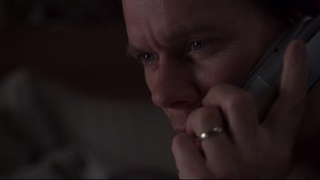 Movie still from “Trapped” (2002), directed by Luis Mandoki – A person talking on a cell phone; Close Up shot, High angle