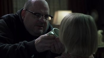Movie still from “Trapped” (2002), directed by Luis Mandoki – A man holding a cup in his hand while a woman holds it; Close Up shot, Over the shoulder angle