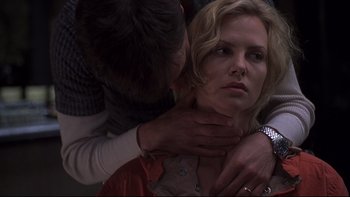 Movie still from “Trapped” (2002), directed by Luis Mandoki – A woman with her hands on her chest; Close Up shot, Low angle