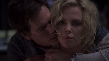 Movie still from “Trapped” (2002), directed by Luis Mandoki – A man and a woman are kissing in a dark room; Close Up shot, Low angle
