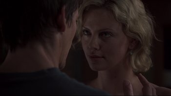 Movie still from “Trapped” (2002), directed by Luis Mandoki – A man and a woman looking at one another in a mirror; Close Up shot, Over the shoulder angle