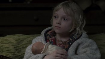 Movie still from “Trapped” (2002), directed by Luis Mandoki – A little girl sitting in a blanket holding a doll; Close Up shot, High angle