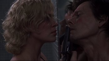 Movie still from “Trapped” (2002), directed by Luis Mandoki – A man and a woman face to face in front of a mirror; Close Up shot, Low angle