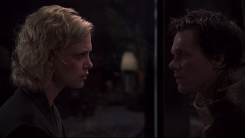 Movie still from “Trapped” (2002), directed by Luis Mandoki – A woman and a man facing each other in a dark room; Close Up shot, Over the shoulder angle