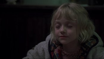 Movie still from “Trapped” (2002), directed by Luis Mandoki – A little girl with her eyes closed; Close Up shot, High angle