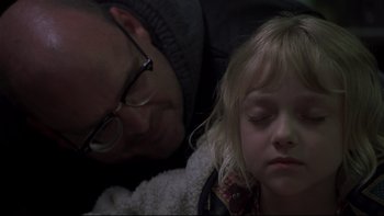 Movie still from “Trapped” (2002), directed by Luis Mandoki – A man and a little girl laying on the ground; Close Up shot, Over the shoulder angle