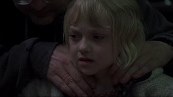 Movie still from “Trapped” (2002), directed by Luis Mandoki – A woman is holding a young girl in her arms; Close Up shot, Over the shoulder angle