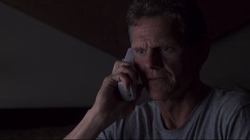 Movie still from “Trapped” (2002), directed by Luis Mandoki – A person talking on a cell phone; Close Up shot, Low angle