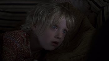 Movie still from “Trapped” (2002), directed by Luis Mandoki – A young girl with blue eyes looking at the camera; Close Up shot, Over the shoulder angle