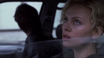 Movie still from “Trapped” (2002), directed by Luis Mandoki – A person in a car looking out the window; Close Up shot, Over the shoulder angle