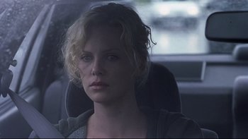 Movie still from “Trapped” (2002), directed by Luis Mandoki – A woman sitting in the back seat of a car; Close Up shot, Over the shoulder angle