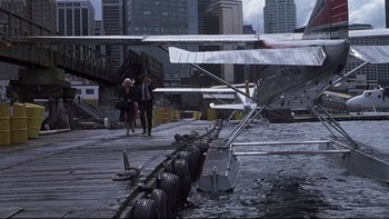 Movie still from “Trapped” (2002), directed by Luis Mandoki – A man and a woman walking on a pier; Wide shot, High angle
