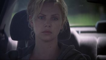 Movie still from “Trapped” (2002), directed by Luis Mandoki – Charlize theron in a car in a scene from the movie; Close Up shot, Over the shoulder angle