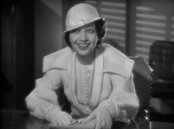Movie still from “Trouble in Paradise” (1932), directed by Ernst Lubitsch – An old photo of a woman wearing a hat and gloves; Medium shot, High angle