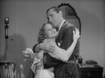 Movie still from “Trouble in Paradise” (1932), directed by Ernst Lubitsch – A man and a woman hugging in a room; Medium shot, Low angle