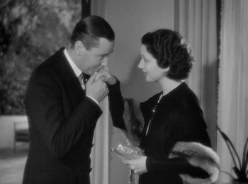 Movie still from “Trouble in Paradise” (1932), directed by Ernst Lubitsch – A man and a woman standing next to each other; Medium shot, High angle