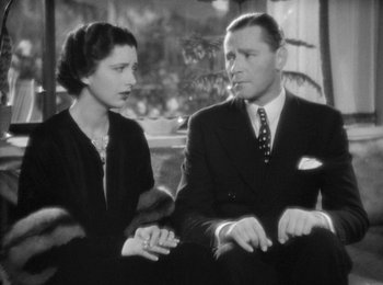 Movie still from “Trouble in Paradise” (1932), directed by Ernst Lubitsch – An old photo of a man and a woman sitting together; Close Up shot, High angle