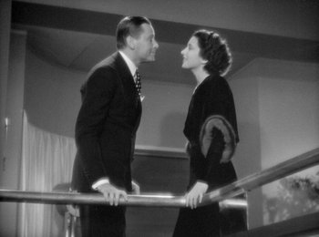 Movie still from “Trouble in Paradise” (1932), directed by Ernst Lubitsch – A man and a woman standing next to a railing; Medium shot, Low angle