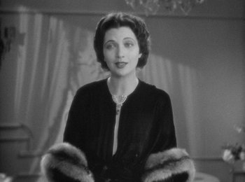 Movie still from “Trouble in Paradise” (1932), directed by Ernst Lubitsch – An old photo of a woman wearing a fur coat; Close Up shot, Low angle
