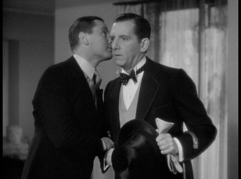 Movie still from “Trouble in Paradise” (1932), directed by Ernst Lubitsch – A man in a suit and tie kissing another man in a suit and tie; Close Up shot, Over the shoulder angle