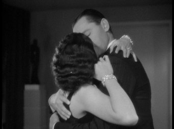 Movie still from “Trouble in Paradise” (1932), directed by Ernst Lubitsch – A man and a woman hugging each other in front of a mirror; Medium shot, Low angle