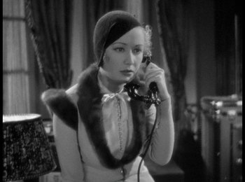 Movie still from “Trouble in Paradise” (1932), directed by Ernst Lubitsch – An old photo of a woman talking on a phone; Close Up shot, High angle