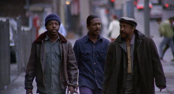 Movie still from “Truck Turner” (1974), directed by Jonathan Kaplan – A group of men walking down a street; Medium shot, Low angle