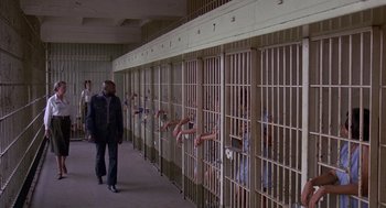 Movie still from “Truck Turner” (1974), directed by Jonathan Kaplan – A group of people reaching out of a jail cell; Wide shot, High angle