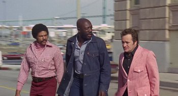 Movie still from “Truck Turner” (1974), directed by Jonathan Kaplan – A group of men walking down a street; Medium shot, Low angle