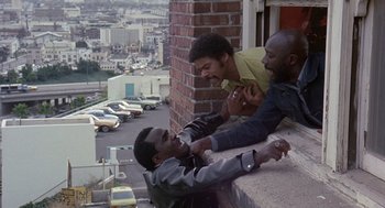 Movie still from “Truck Turner” (1974), directed by Jonathan Kaplan – A group of men standing next to each other on a ledge; Medium shot, High angle