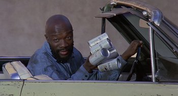 Movie still from “Truck Turner” (1974), directed by Jonathan Kaplan – A man holding a can of beer in his hand; Close Up shot, High angle